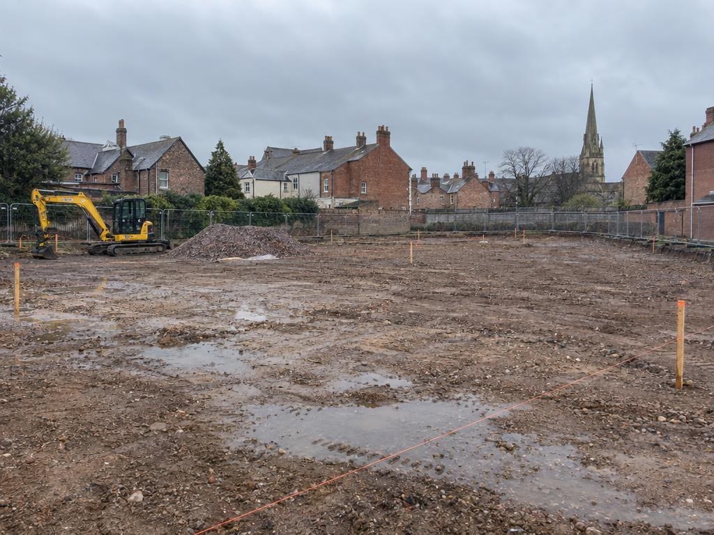 Cleared development site with survey stakes
